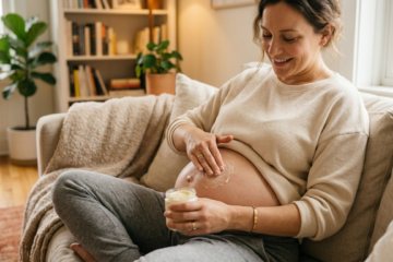 pregnant person applying belly butter on baby bump for stretch mark prevention
