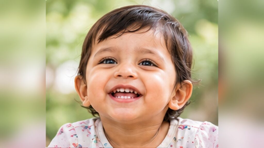 Smiling baby showing her first tooth
